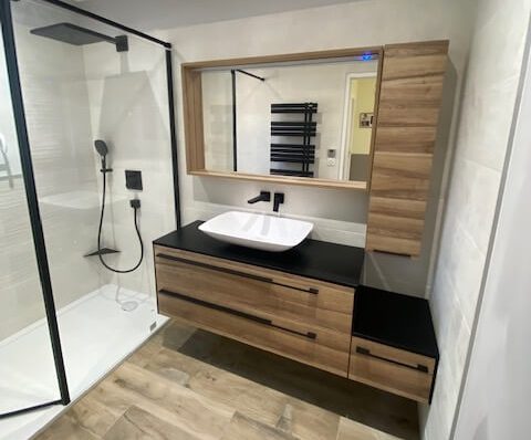 Provence salle de bain Salon de Provence Salle de bain moderne avec douche, meuble en bois et lavabo sur plan en quartz noir.