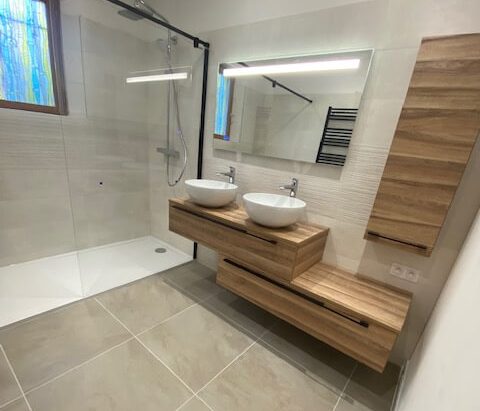 Provence salle de bain Salon de Provence Salle de bain moderne avec meuble en bois, lavabos doubles et douche vitrée.